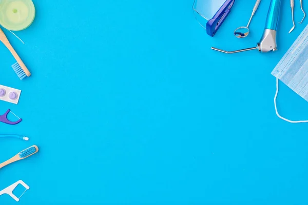 Tandläkare verktyg över blå bakgrund ovanifrån — Stockfoto