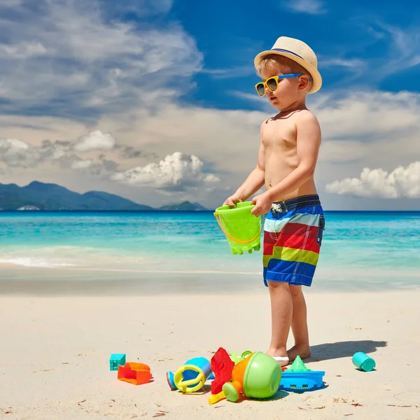 ビーチでビーチのおもちゃで遊んでいる3歳の幼児の少年 セーシェルでの夏休み — ストック写真