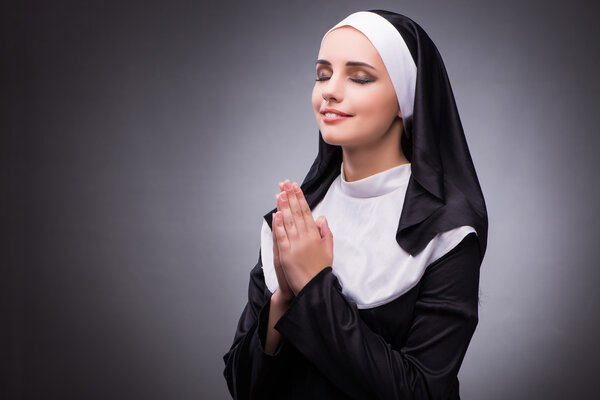 Religious nun in religion concept against dark background