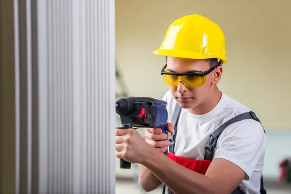 Uomo foratura del muro con perforatore — Foto Stock