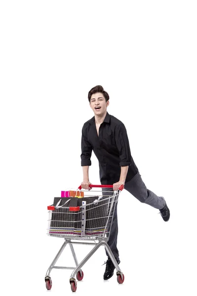 Young man with shopping cart and bags isolated on white — Stock Photo, Image