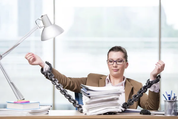 Woman chained to her working desk