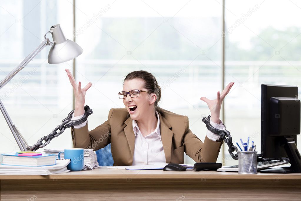 Woman chained to her working desk