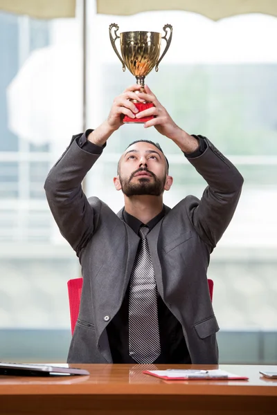 Businessman with winners cup trophy in business concept Stock Picture