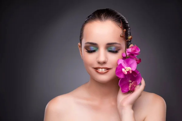 Beautiful woman with orchid flower — Stock Photo, Image