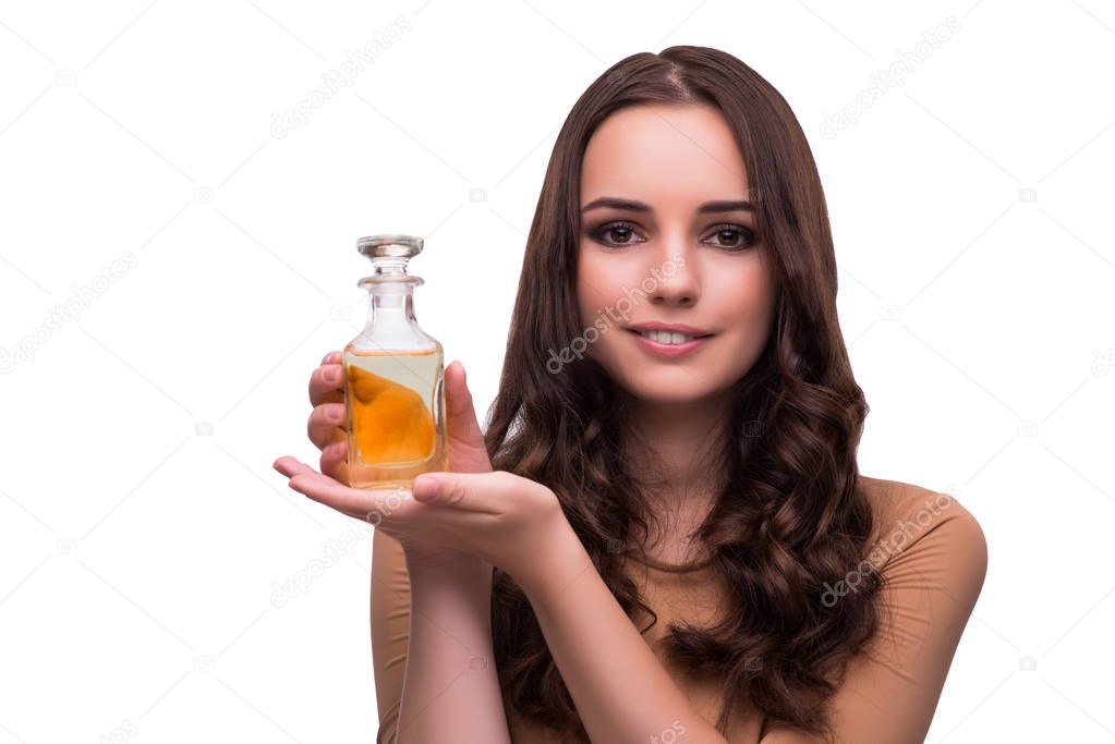 Young woman with perfume bottle isolated on white