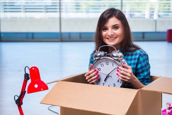 Young woman moving personal belongings
