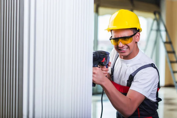 Man drilling the wall with drill perforator — Stock Photo, Image