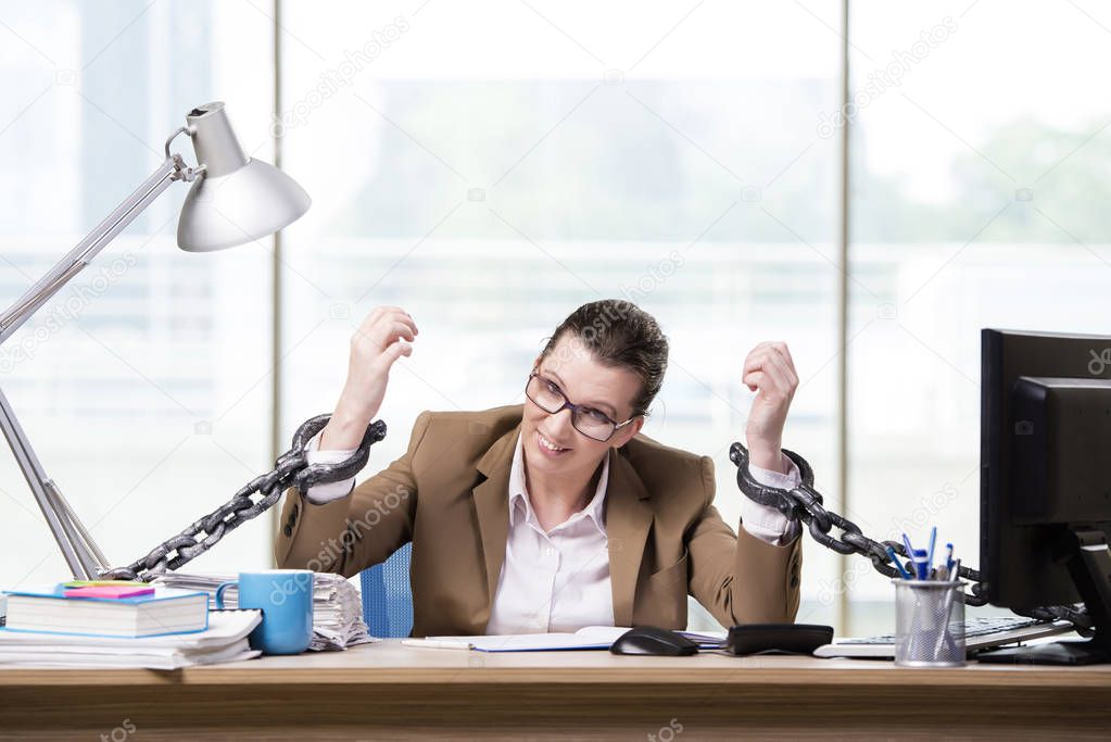 Woman chained to her working desk