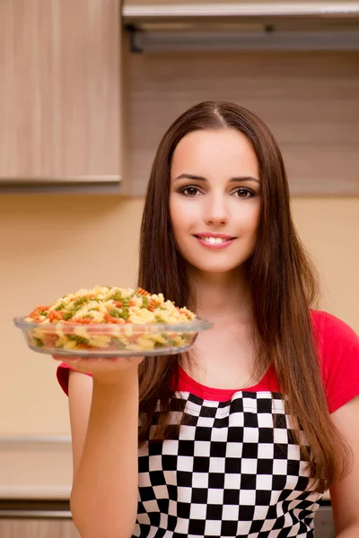 Young woman housewife working in the kitchen — Stock Photo, Image