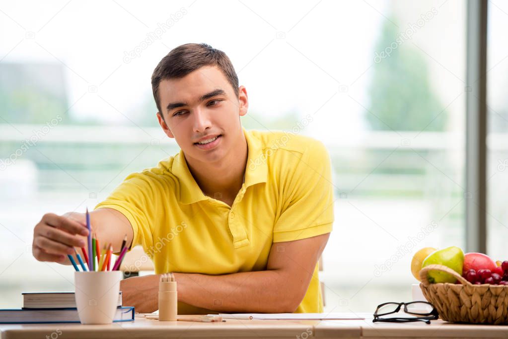 Young man drawing pictures in studio
