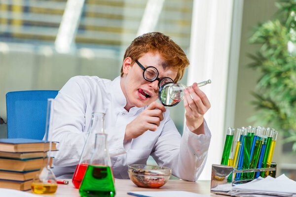 Young crazy chemist working in the lab