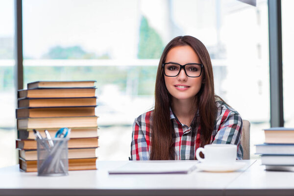 Young woman student with many books