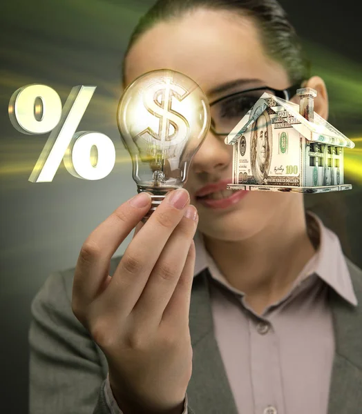 Young woman with lightbulb in mortgage concept — Stock Photo, Image