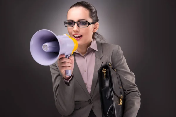 Young businesswoman with loudspeaker in business concept — Stock Photo, Image