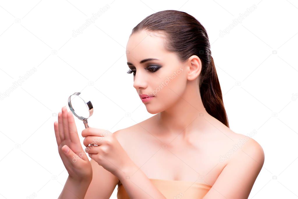 Woman examining her nails with magnifying lens
