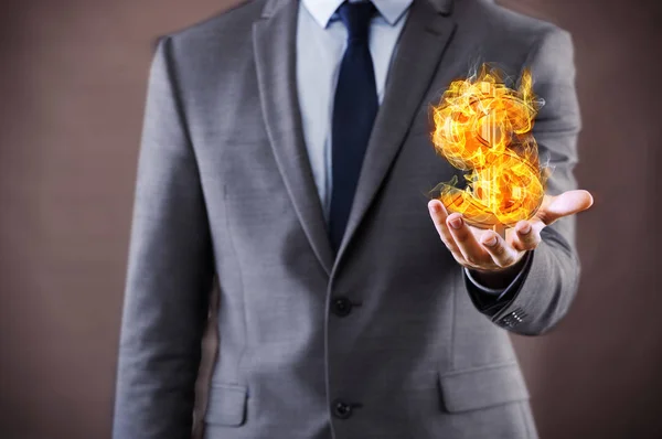 Businessman holding burning american dollar sign — Stock Photo, Image