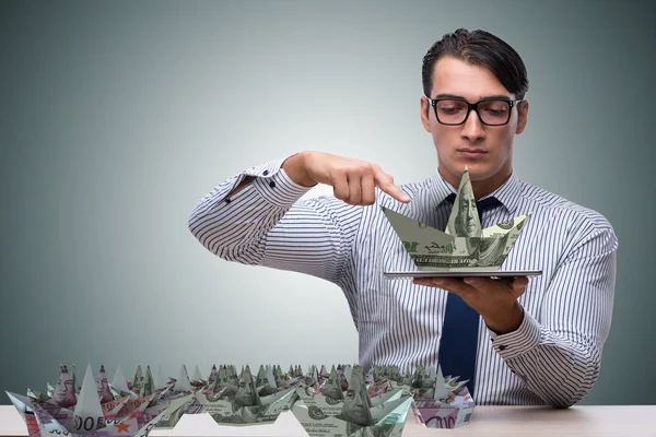 Businessman with dollar paper boats — Stock Photo, Image