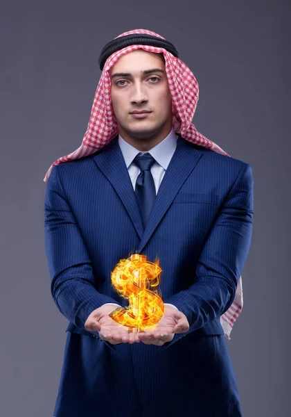 Arab businessman with burning dollar sign — Stock Photo, Image