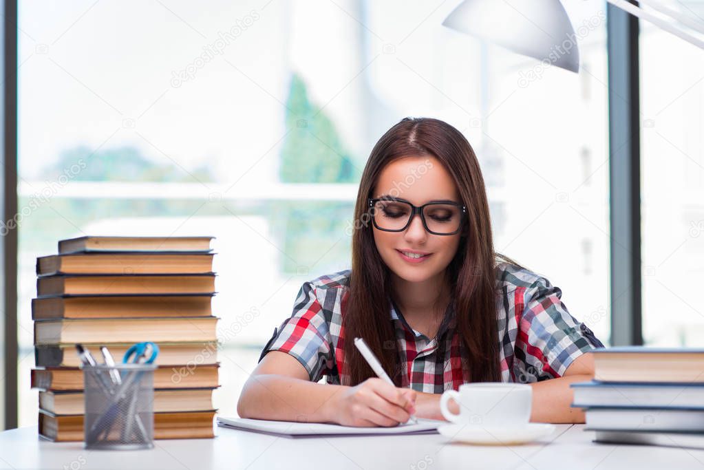 Young woman student with many books
