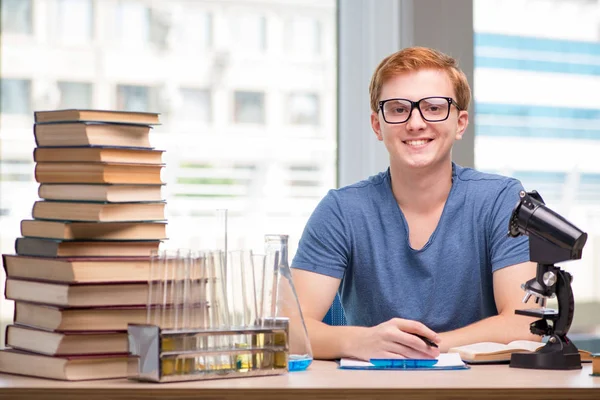 Joven estudiante cansado y agotado preparándose para el examen de química — Foto de Stock