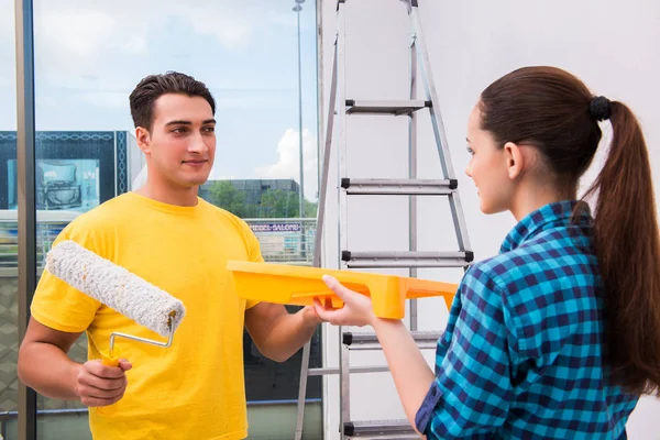 Young couple painting wall at home — Stock Photo, Image