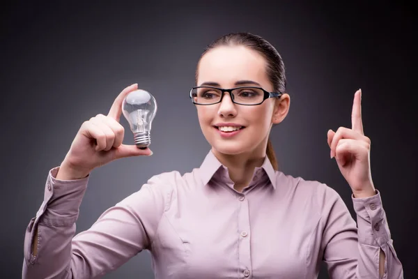 Young businesswoman in idea concept with light bulb — Stock Photo, Image