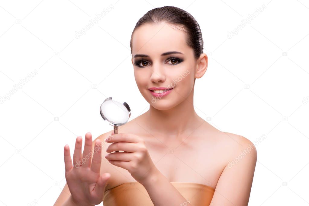Woman examining her nails with magnifying lens