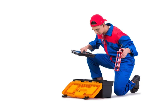 Joven reparador con pistola de silicona aislada en blanco — Foto de Stock