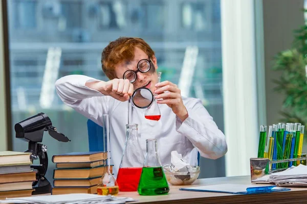 A laborban dolgozó fiatal őrült kémikus — Stock Fotó