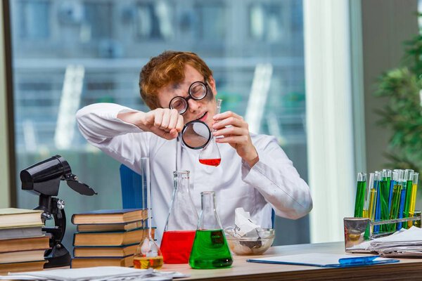 Young crazy chemist working in the lab