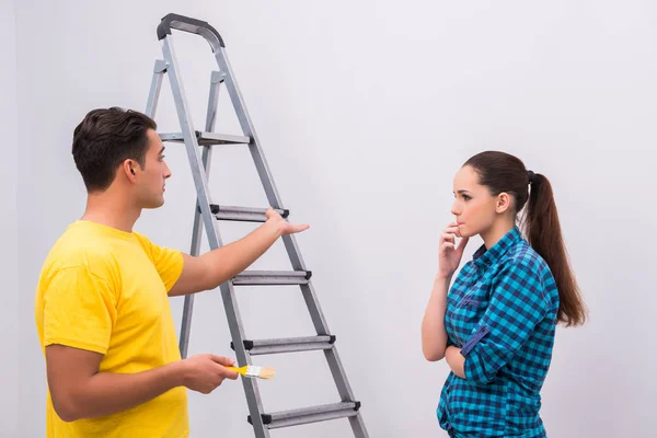 Young couple painting wall at home — Stock Photo, Image