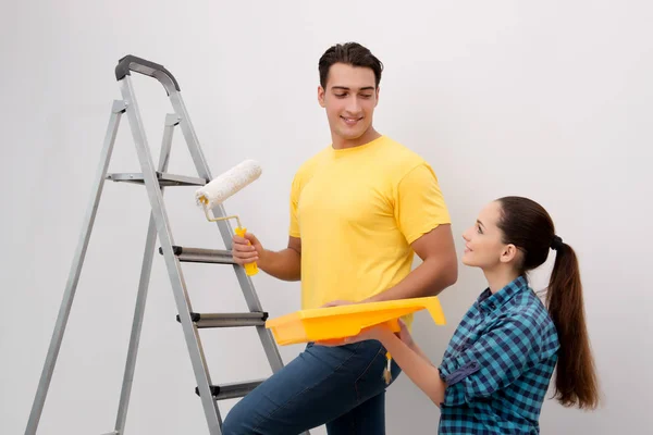 Young couple painting wall at home — Stock Photo, Image