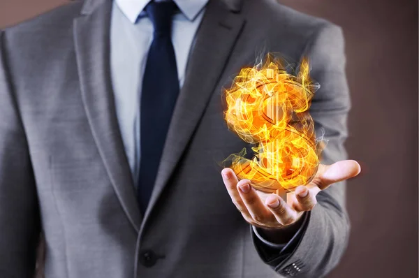 Businessman holding burning american dollar sign — Stock Photo, Image