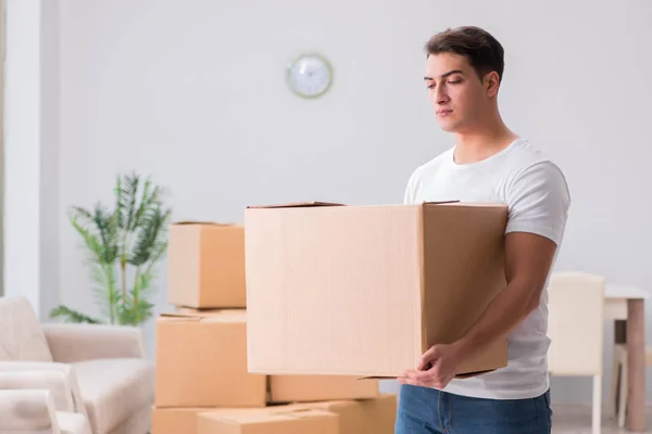 Man delivering heavy boxes at home