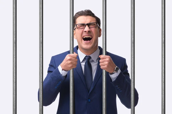 Young businessman behind the bars in prison — Stock Photo, Image