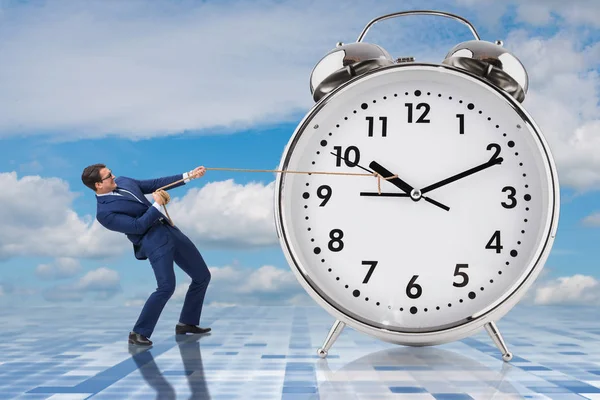 Businessman pulling clock in time management concept — Stock Photo, Image