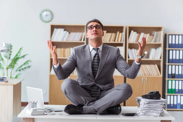 Handsome meditating on the office desk — Stock Photo, Image