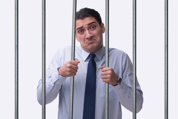 Young businessman behind the bars in prison — Stock Photo, Image