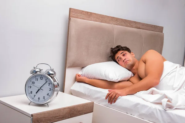 Man having trouble waking up in the morning