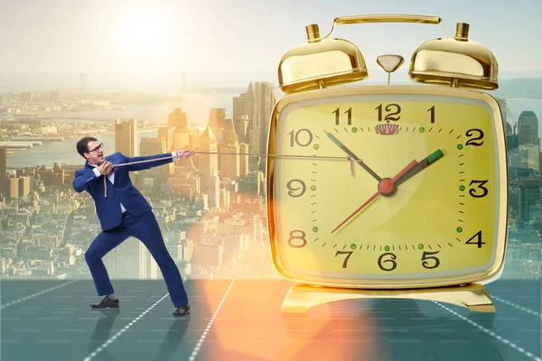 Businessman pulling clock in time management concept — Stock Photo, Image