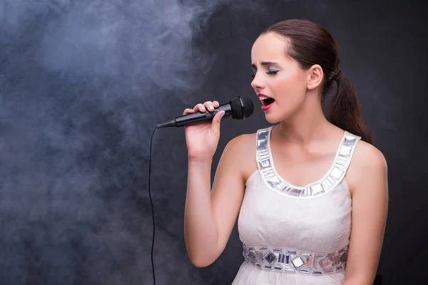 Young girl singing in karaoke club — Stock Photo, Image