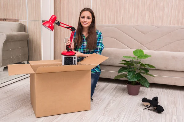 Young woman packing personal belongings