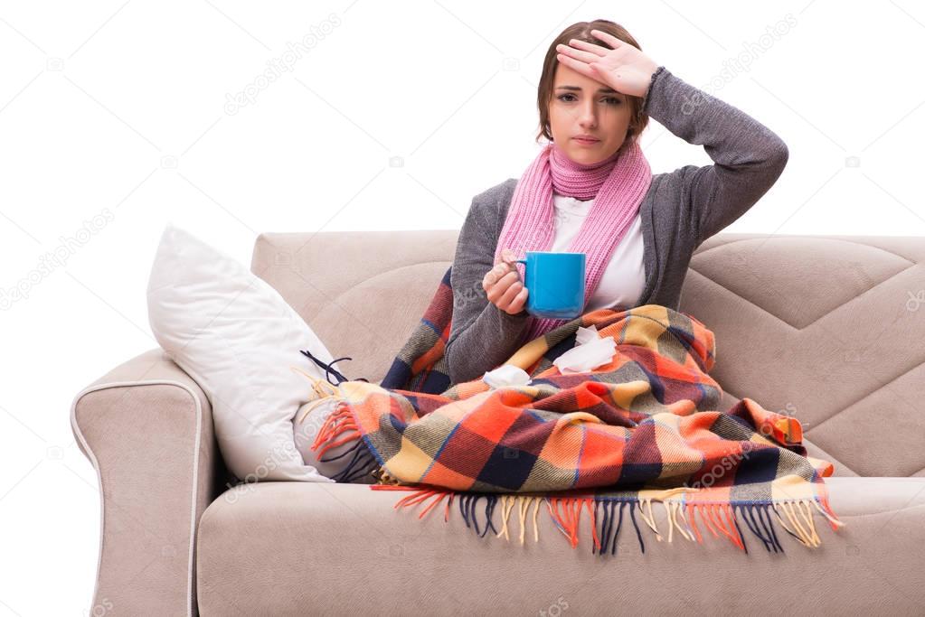 Young woman drinking tea during fever