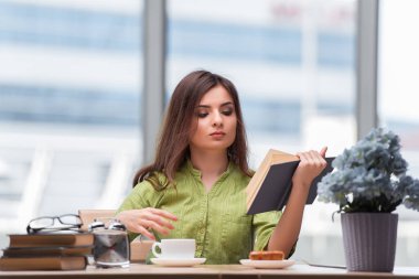 Sınavlara hazırlanan genç öğrenci çay içiyor.