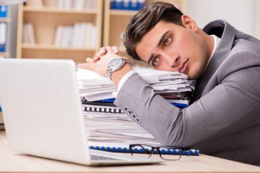 Businessman tired sitting in the office clipart