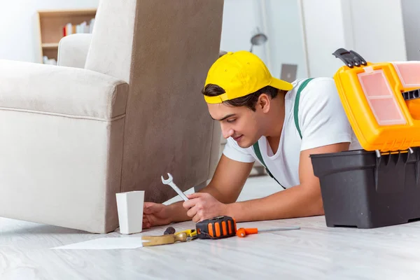 Worker repairing furniture at home