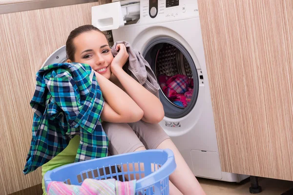 Young wife woman washing clothes near machine — Stock Photo, Image