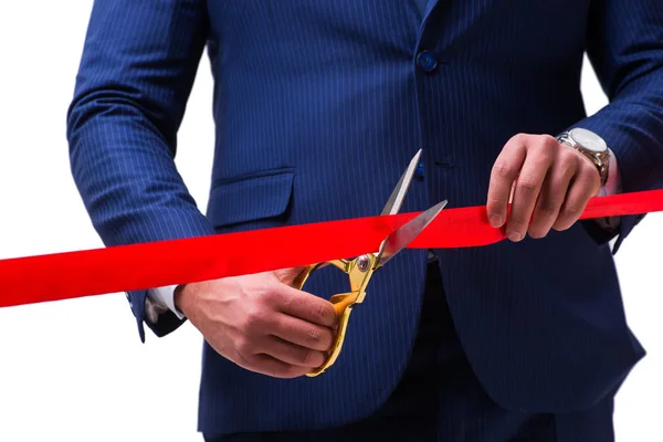 Businessman cutting red ribbon isolated on white — Stock Photo, Image