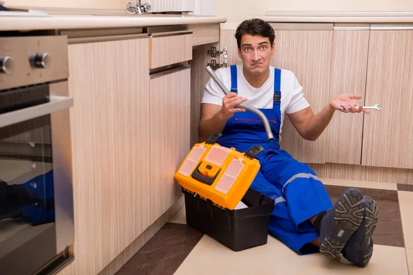 Junger Reparateur arbeitet in der Küche — Stockfoto